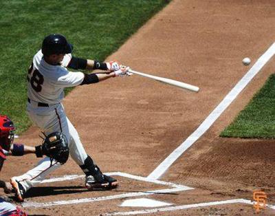 After contact, top hand starts to rotate as hitter follows through
