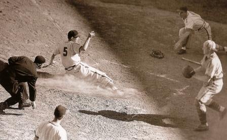 checking to be sure the runner touches home plate