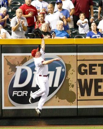 Jason Kubel bringing one back into the park to save some runs, ball is above the wall