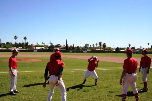 player with two hands up, catching both balls simultaneously