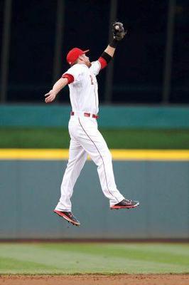 Shortstop getting up high to catch line drive.